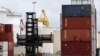 A worker moves containers at the compound of ports operator DP World at Port Botany in Sydney, Nov. 13, 2023. Major ports handling 40% of Australia's freight trade have resumed operations, leading operator DP World said. 