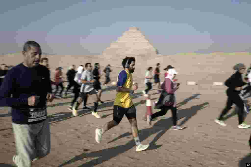 Runners participate in the 10-kilometer Saqqara Pyramid Race at the site of the Step Pyramid of Djoser in Saqqara, southwest of Cairo, Egypt.