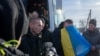 Swapped Ukrainian prisoners of war disembark from a bus after a prisoner exchange for Russian POWs, at an unidentified location in Ukraine, Jan. 31, 2024. (Ukrainian Presidential Press Service/Handout via Reuters)