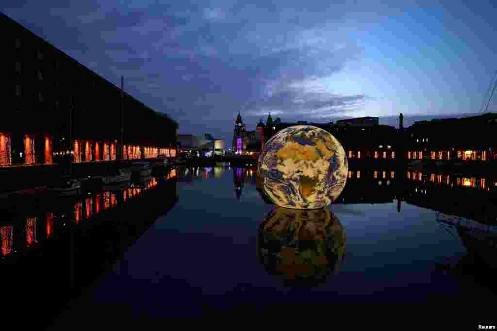 Luke Jerram's 'Floating Earth', an art installation as part of the Eurovision celebrations is seen in the Albert Dock in Liverpool, Britain.
