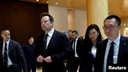 资料照片：特斯拉首席执行官马斯克与特斯拉高管一道离开北京的一家酒店。(2023年5月31日)