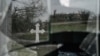 FILE - A cross is reflected on a broken window of a village church in Ukraine's southern Kherson region, amid Russia's invasion of its neighbor, Dec. 30, 2022.
