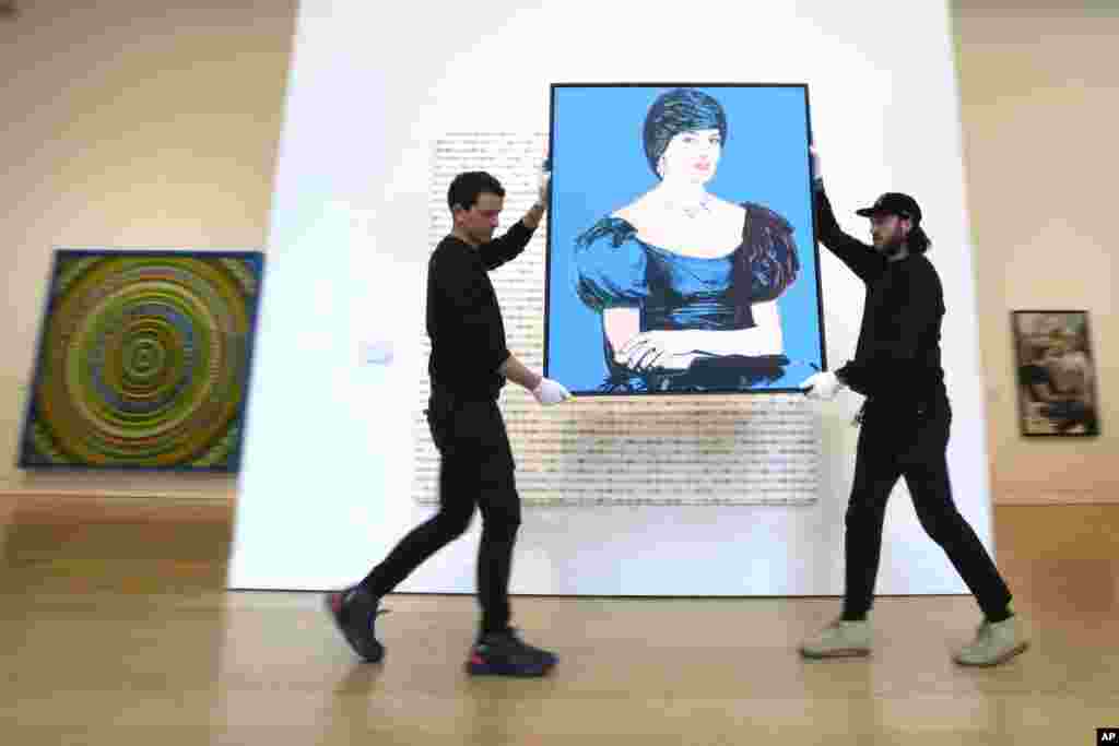 Art handlers carry an Andy Warhol portrait of Princess Diana created in 1982, as it is displayed at Phillips auction rooms in London. The painting will be auctioned estimated at 1,200,00 - 1,800,00 UK Pounds ($1,520,000 - 2,280,000) in the London 20th Century and Contemporary Art Sales on March 7 and 8. 