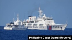 菲律宾海岸警卫队发布照片显示，2023年6月30日一艘中国海警船被指在有争议的南中国海海域骚扰为菲律宾海军运送后勤物资的船只。