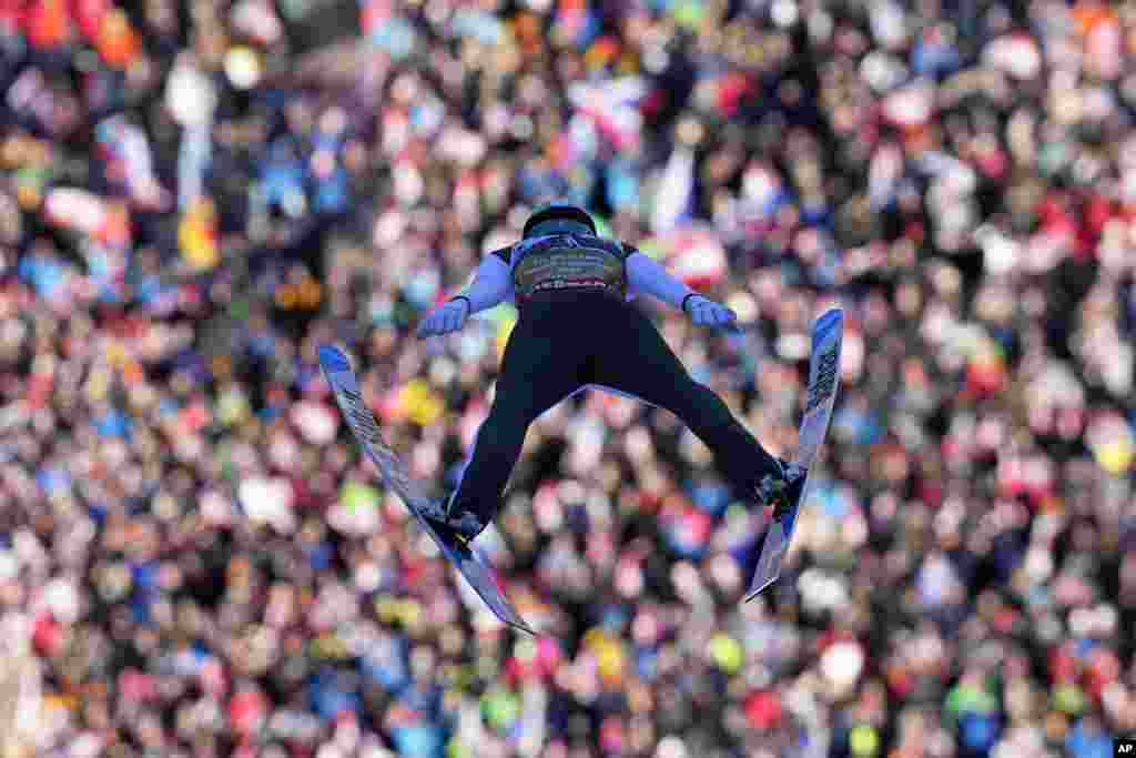 Lovro Kos of Slovenia soars through the air during his first round jump of the Men Team competition at the ski flying world championships, at the Kulmkogel mountain in Bad Mitterndorf, Austria.