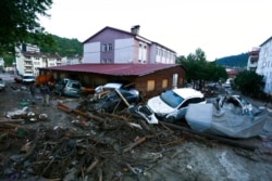 Destroyed cars lie in a street after floods and mudslides in Bozkurt town, Kastamonu province, Turkey, Aug. 12, 2021. Floods triggered by torrential rains battered the Black Sea coastal provinces of Bartin, Kastamonu, Sinop and Samsun on Wednesday.