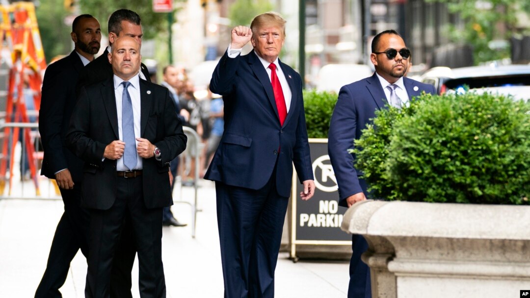 Former President Donald Trump gestures as he departs Trump Tower, Wednesday, Aug. 10, 2022, in New York, on his way to the New York attorney general's office for a deposition in a civil investigation.