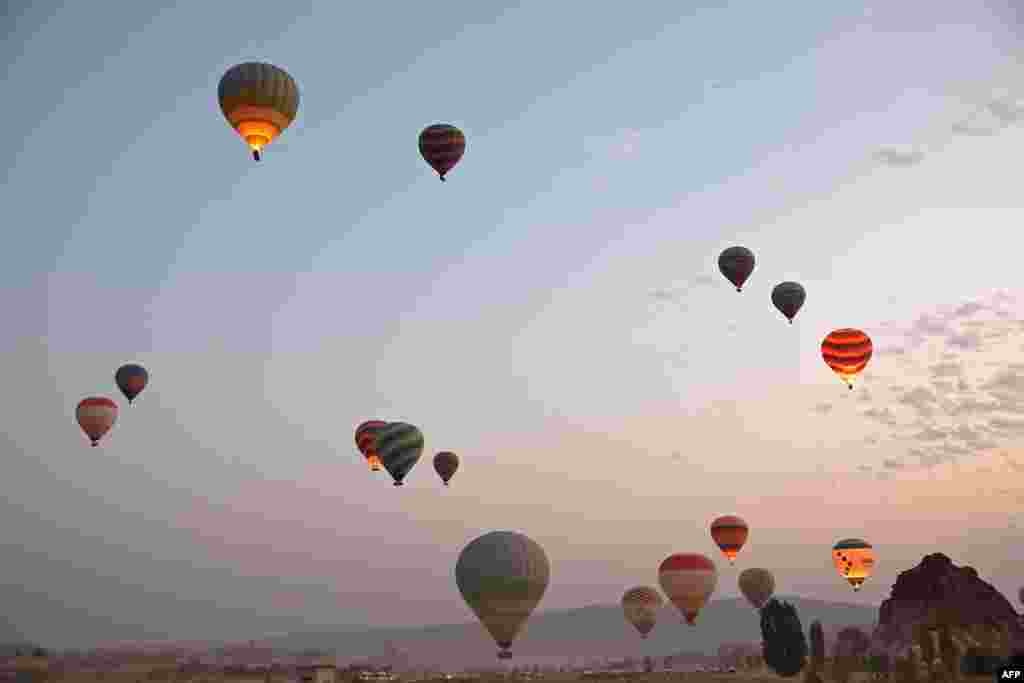 Sight-seeing hot air balloons launch in Goreme Historical National Park, east of Nevesehir (Neapolis) in central Turkey's historical Cappadocia (Kapadokya) region, Aug. 24, 2022.