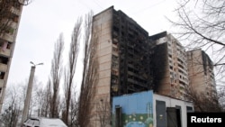 Зруйновані житлові будинки після початку повномасштабного російського вторгнення, Харків, 9 березня 2022. REUTERS/Oleksandr Lapshyn
