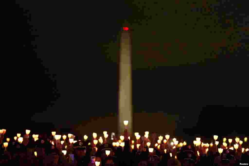 People hold candles at the National Law Enforcement Officers Memorial Fund’s 30th annual candlelight vigil in Washington, May 13, 2018.