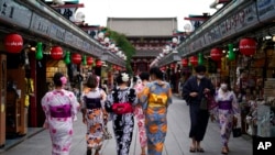 2020年7月27日，身穿传统和服的游客在东京浅草区行走。