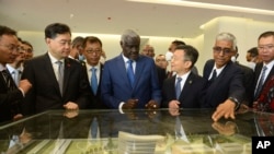 2023年1月11日，中国外交部长秦刚(左二)和非盟委员会主席穆萨·法基·马哈马特(中)在埃塞俄比亚亚的斯亚贝巴出席非洲疾病控制和预防中心的落成典礼。（美联社）