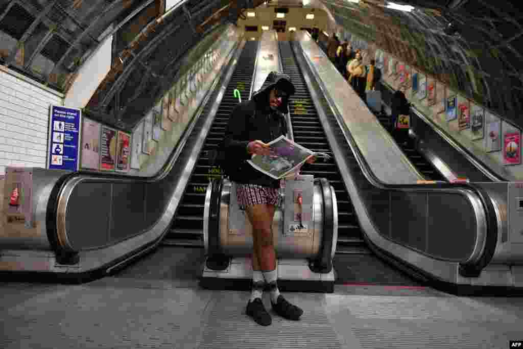 A man reads a newspaper as he takes part in the annual 'No Trousers On The Tube Day' (No Pants Subway Ride) at Liverpool Street Station in London.