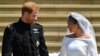 Britain's Prince Harry, Duke of Sussex and his wife Meghan, Duchess of Sussex, leave from the West Door of St George's Chapel, Windsor Castle, in Windsor, on May 19, 2018, after their wedding ceremony. 