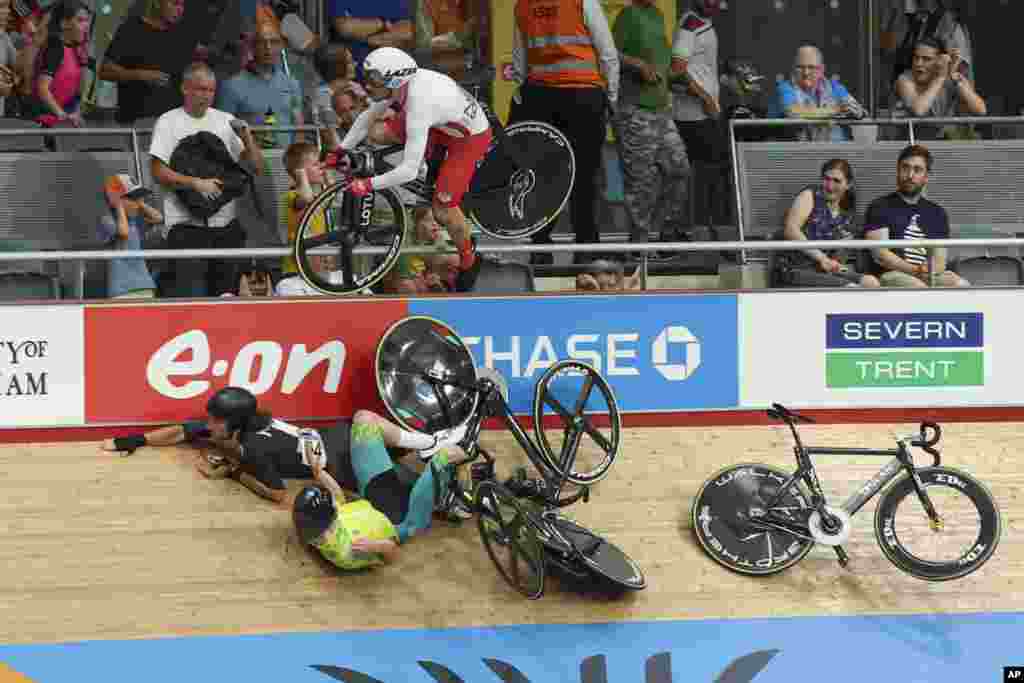 Riders crash on the final lap in the men's 15km scratch race qualifying during the Commonwealth Games track cycling at Lee Valley VeloPark in London.