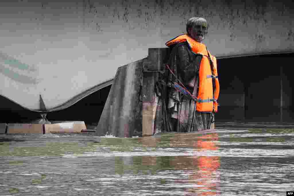 The Zouave statue of the Pont D'Alma bridge standing partially submerged after the River Seine burst its banks in Paris, France, wears a life jacket put by activists of the Fondation Goodplanet.