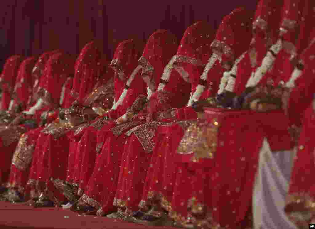 Indian Muslim brides sit during a mass marriage where 63 couples were married in Mumbai.