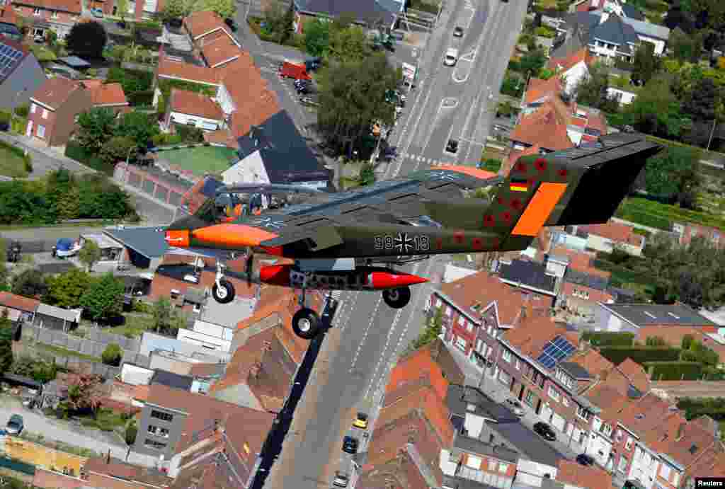 An OV-10 Bronco aircraft, decorated with World War I commemoration motifs, flies over Flanders international airport, ahead of the world's first Short Take Off & Landing competition on sand, in Wevelgem, Belgium.