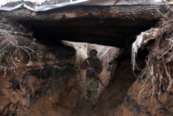 A Ukrainian serviceman patrols along a position at the front line with Russia-backed separatists not far from Avdiivka, Donetsk region, April 5, 2021.