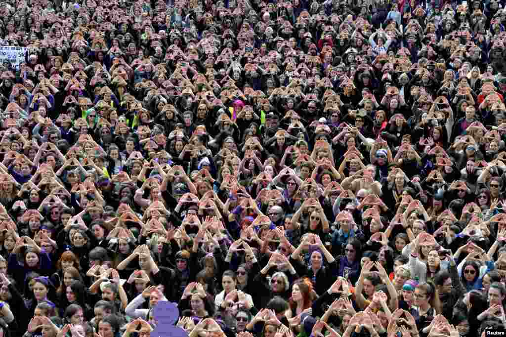 Protesters form triangles with their hands during a demonstration for women's rights in Bilbao, Spain, on International Women's Day.