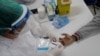 A health worker gives a resident a COVID-19 test on the first day of a three-day vaccination campaign for people over age 35 in the Complexo da Maré favela of Rio de Janeiro, Brazil, July 29, 2021.