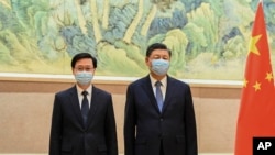 资料照：中国领导人习近平在北京会见新当选的香港特首李家超。（2022年5月30日）