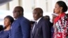 Congolese President Felix Tshisekedi, second left, his wife Denise Nyekeru, outgoing president Jospeh Kabila and his wife Olive Lembe di Sita , listen to the national anthem during the inauguration ceremony, in Kinshasa Thursday Jan. 24, 2019. 