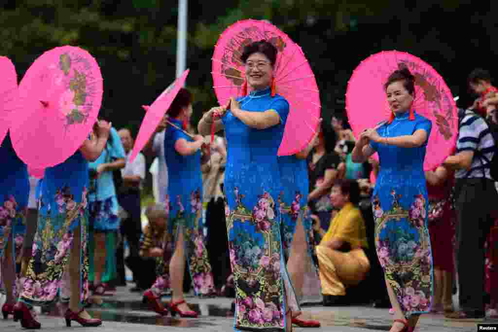 Women take part in a Cheongsam Show ahead of International Women's Day in Qionghai, Hainan province, China.