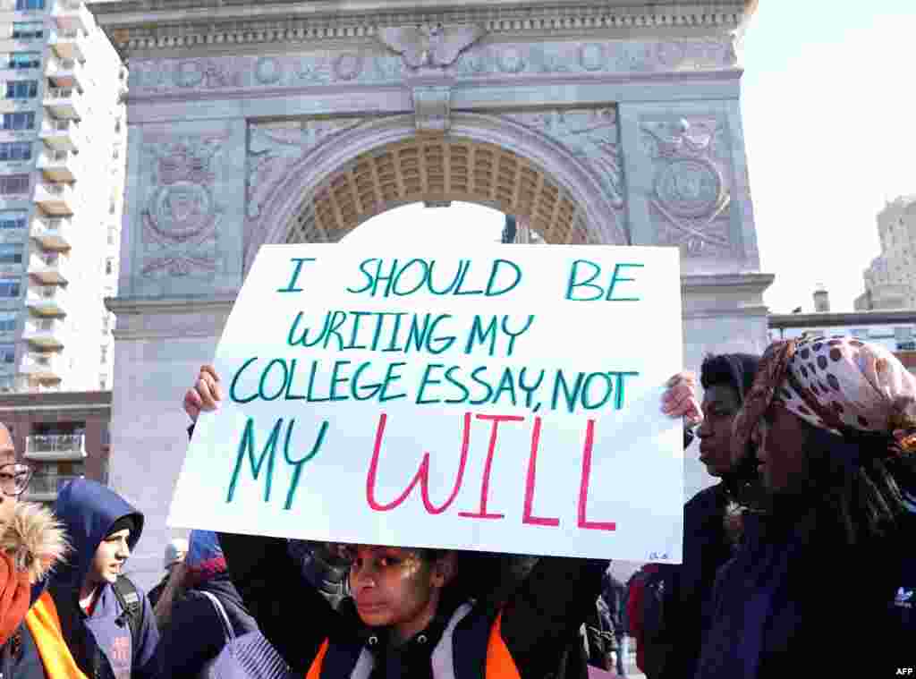 Students from Harvest Collegiate High School stand in Washington Square Park in New York to take part in a national walkout to protest gun violence, one month after the shooting in Parkland, Florida, in which 17 people were killed.