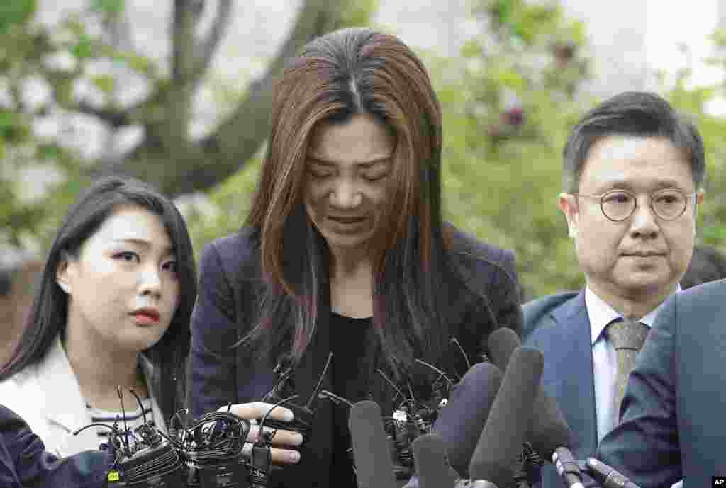 Former Korean Air Senior Vice President Cho Hyun-min, center, speaks as she arrives at a police station in Seoul, South Korea. The Korean Air heiress apologized in her first public appearance as a suspect in an abuse of power case as public calls urging her family to resign grow.