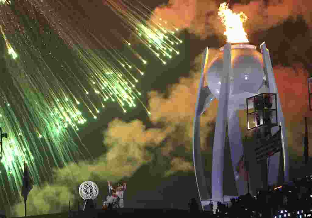 Fireworks explode as the Olympic cauldron is lit during opening ceremony of the 2018 Winter Paralympics in Pyeongchang, South Korea, Friday, March 9, 2018.