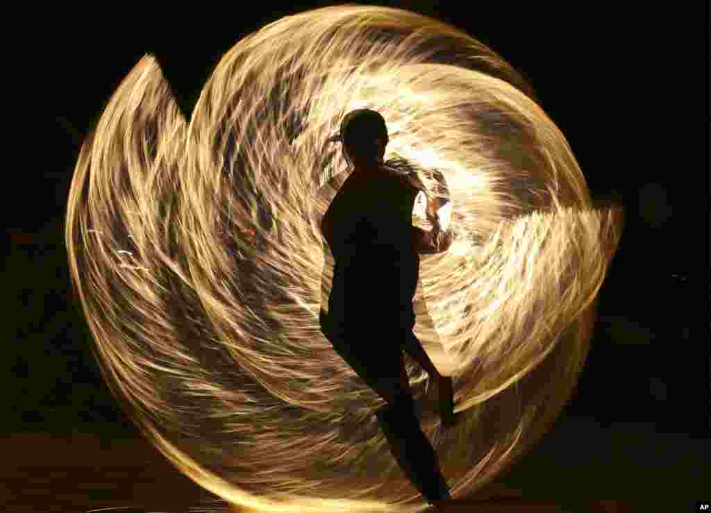 A Filipino fire dancer performs for the last time a day before the government implements the temporary closure of the country's most famous beach resort island of Boracay, in central Aklan province, Philippines.