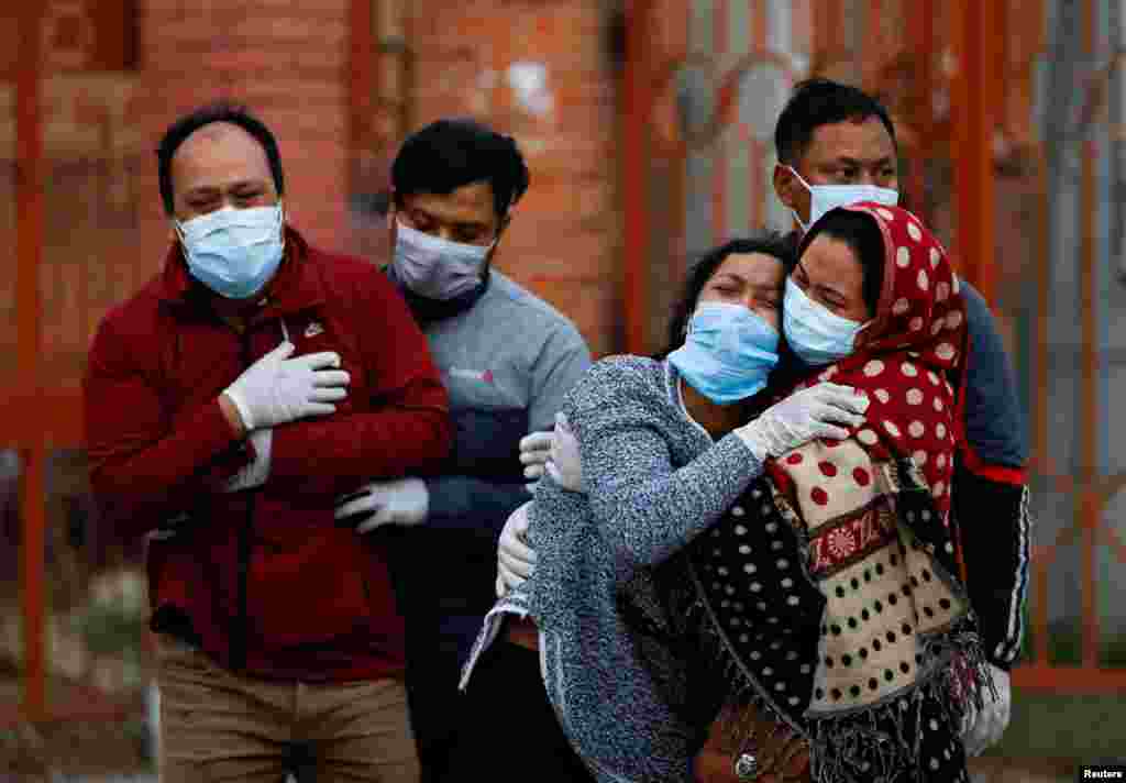 Family members mourn a COVID-19 victim as the country recorded the highest daily increase in death since the pandemic began, in Kathmandu, Nepal.