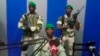 In this image from TV, a soldier who identified himself as Lt. Obiang Ondo Kelly, commander of the Republican Guard, reads a statement on state television broadcast from Libreville, saying the military has seized control of the government, Jan. 7, 2019.