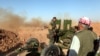 FILE - Kurdish Peshmerga forces fire a weapon during clashes with Islamic State militants in a village east of Mosul, Iraq, May 29, 2016. 