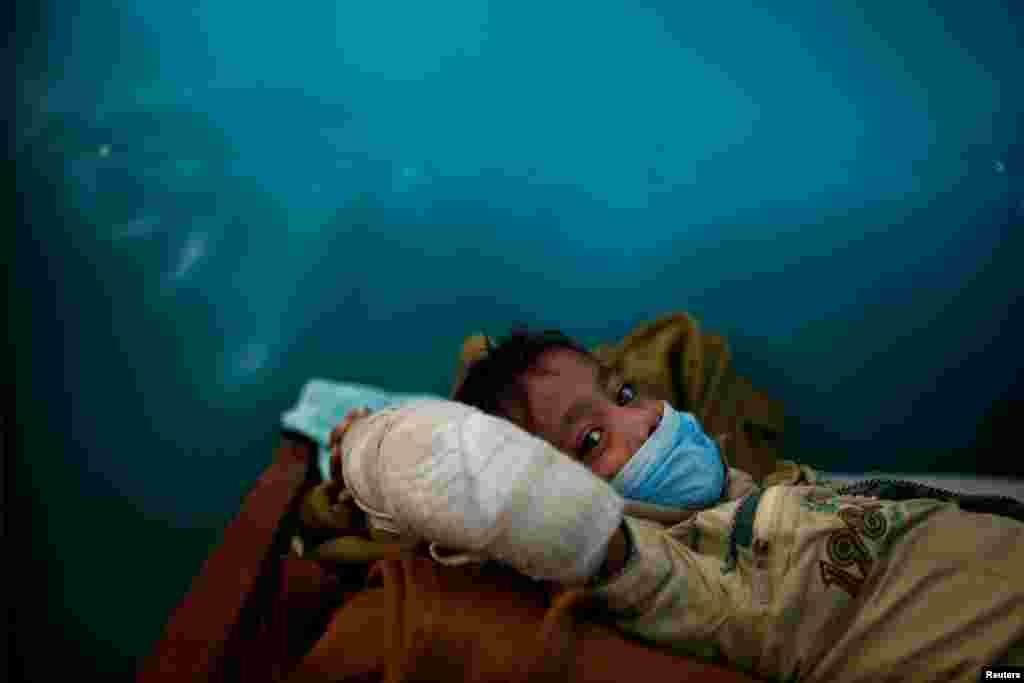 Rohingya refugee Yasin Arfat, 6, who suffers from diphtheria, lays on a bed at a Medecins Sans Frontieres (MSF) clinic near Cox's Bazar, Bangladesh.
