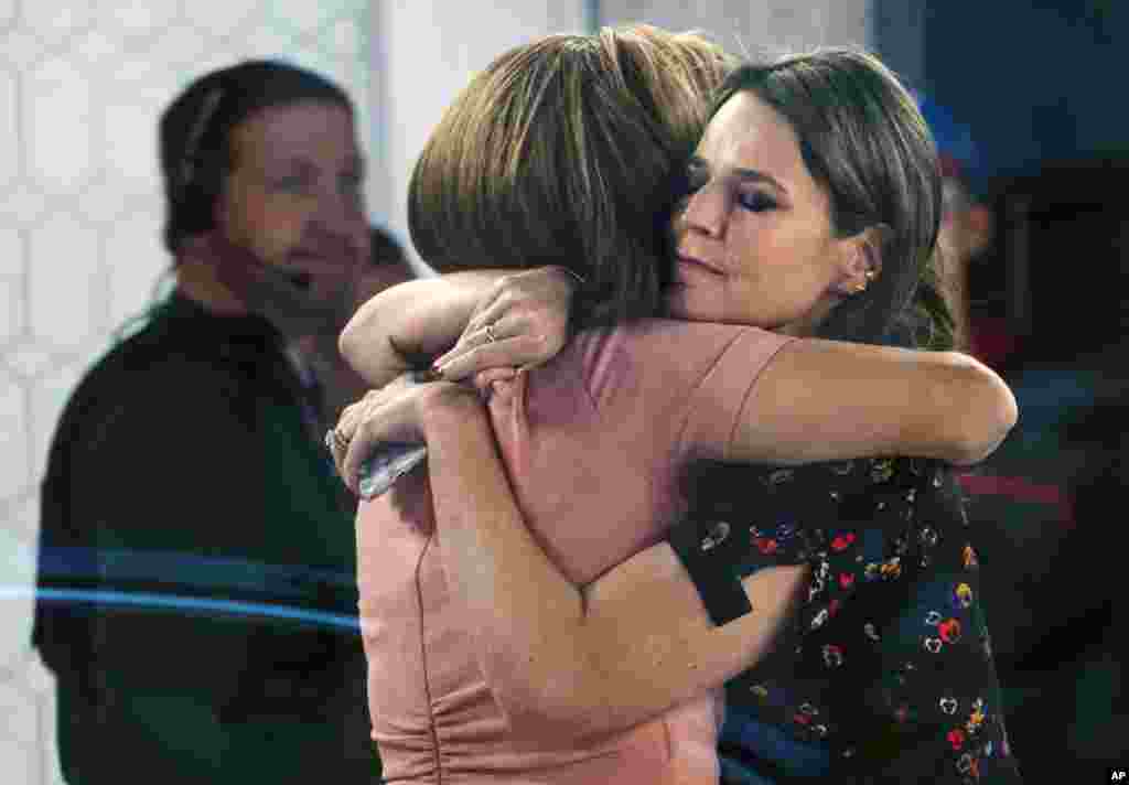 Co-anchors Hoda Kotb, left, and Savannah Guthrie embrace on the set of the "Today" show in New York, after NBC News fired host Matt Lauer. NBC News announced that Lauer was fired for "inappropriate sexual behavior."