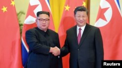中国领导人习近平在北京接见到访的朝鲜领导人金正恩。 （2018年6月20日）