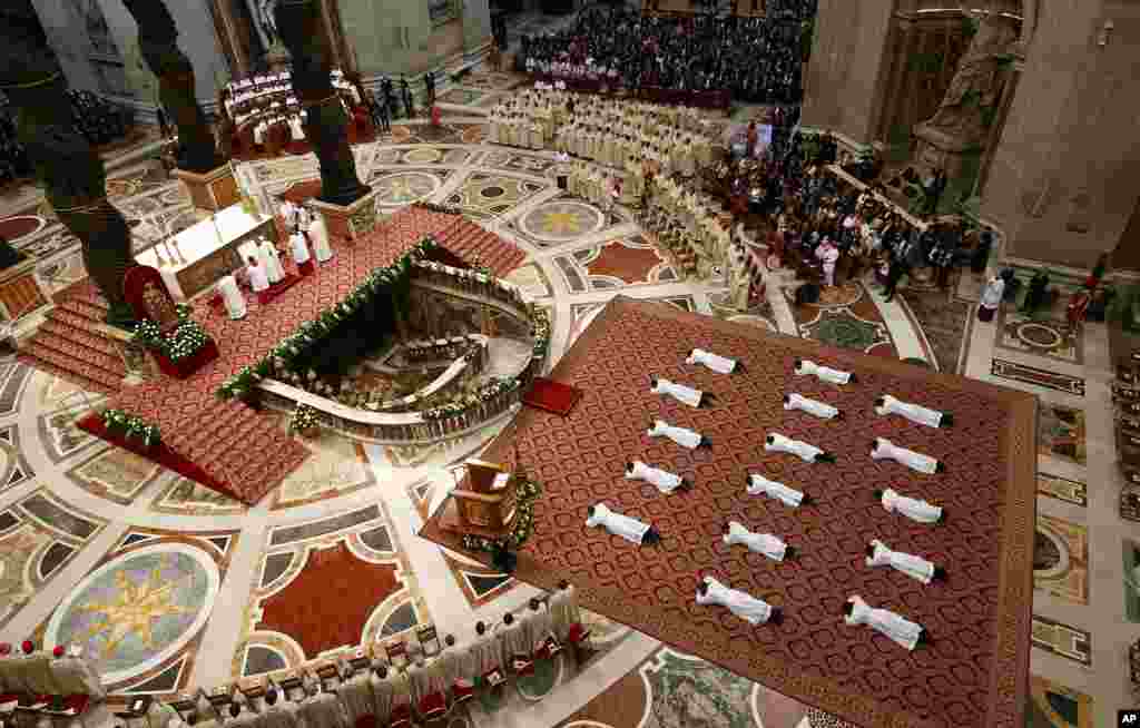 New priests lie face down on the floor during an ordination ceremony presided over by Pope Francis, in St. Peter's Basilica at the Vatican.
