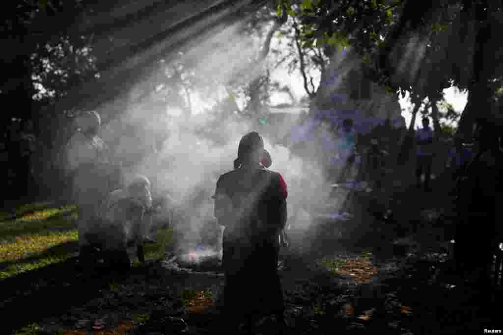 People participate in a traditional ceremony to commemorate the victims of the 1932 Salvadoran peasant massacre in Izalco, El Salvador, Jan. 22, 2018.