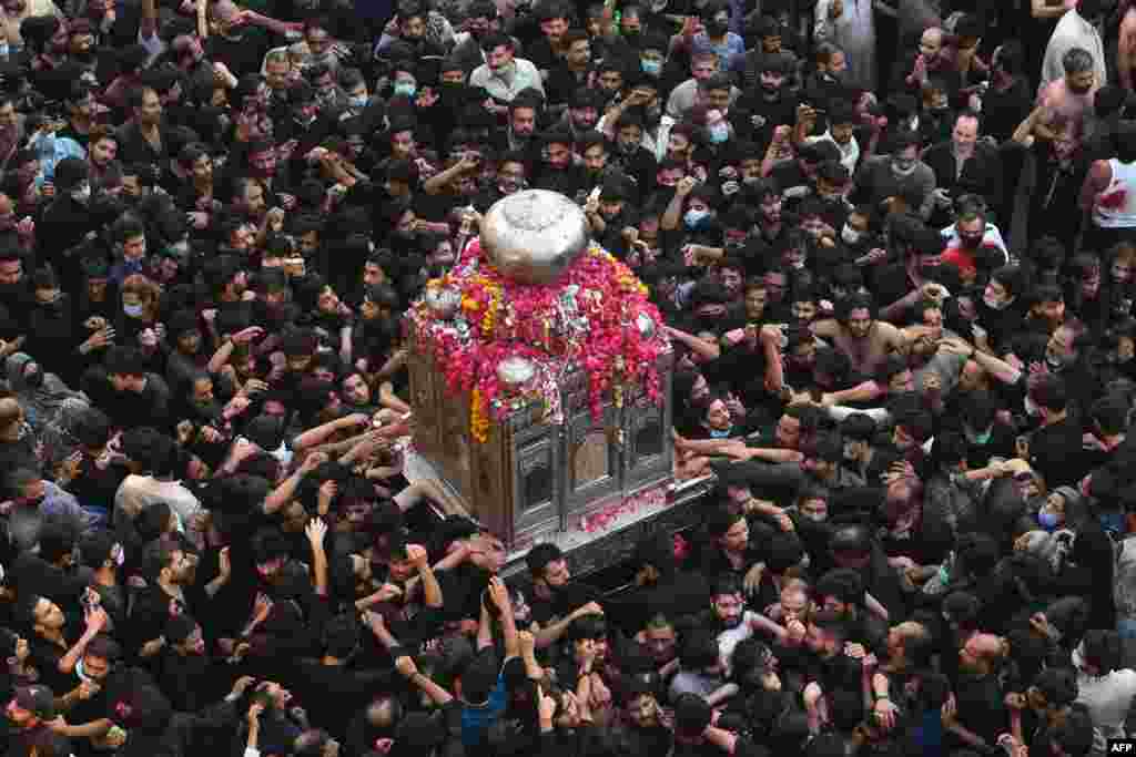 Shi'ite Muslim devotees take part in a procession to commemorate the death anniversary of Prophet Mohammad's companion and son-in-law Imam Ali in Lahore, Pakistan.