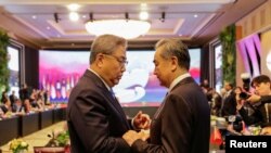 韩国外交部长朴振（左）在印尼雅加达出席东盟外长会议期间与中国最高外交官、中央外办主任王毅会面。（路透社）