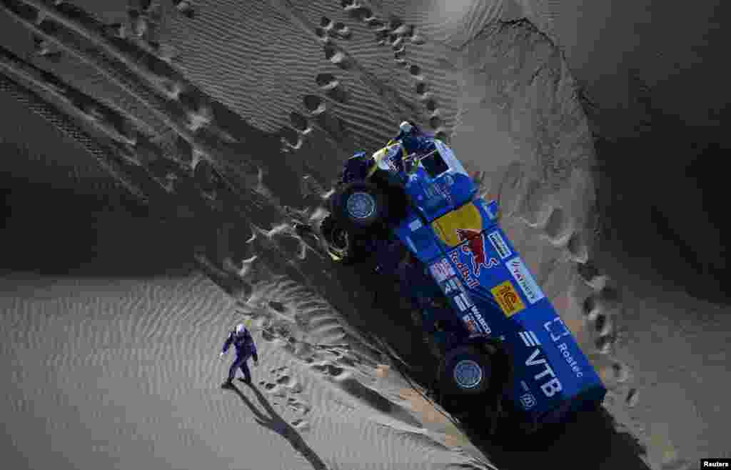 Eduard Nikolaev and co-pilot Evgeny Yakovlev of Russia work on their Kamaz truck during the 2018 Peru-Bolivia-Argentina Dakar rally.