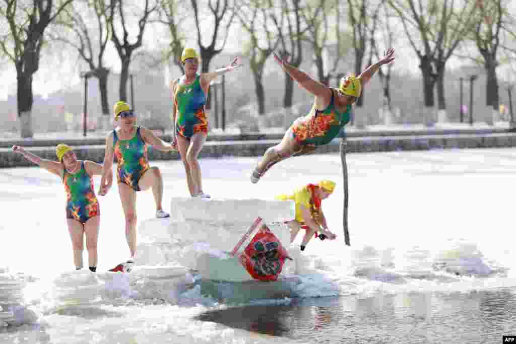 A woman dives into a partly frozen lake in Shenyang in China's northeastern Liaoning province.