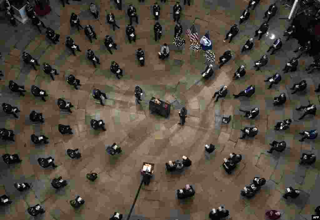 Senate Majority Leader Chuck Schumer of N.Y., speaks during a ceremony memorializing U.S. Capitol Police officer Brian Sicknick, as an urn with his cremated remains lies in honor on a black-draped table at the center of the Capitol Rotunda in Washington.