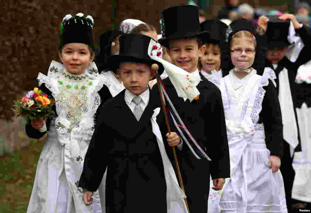 Children of the German Slavic ethnic minority Sorben wear traditional clothes during a parade to celebrate the traditional "Ptaci Kwas" (Vogelhochzeit/marriage of the birds). The festival is held every Jan. 25, when birds thank children for feeding them during the winter and mark the season coming to an end, in Nebelschuetz, east of Dresden, Germany.
