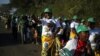 Supporters of Zimbabwe African National Union Patriotic Front (ZANU-PF) party react after attending their final rally at the National Sports Stadium in Harare, Zimbabwe, July 28, 2018. 