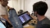 Bart Sights, head of the Eureka Lab, left, and Aykut Aygun, manager of technical innovation, give a demonstration on designing jeans at Levi's innovation lab in San Francisco, Feb. 9, 2018.