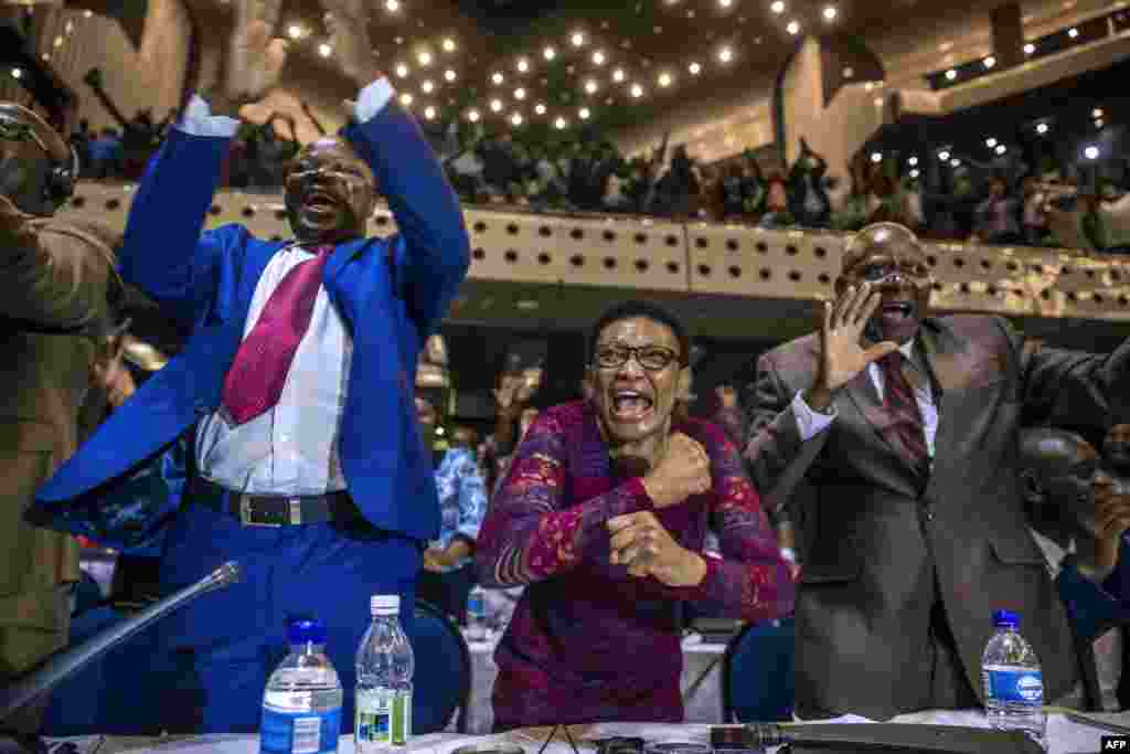 Zimbabwe's members of parliament celebrate after President Robert Mugabe's resignation in Harare.