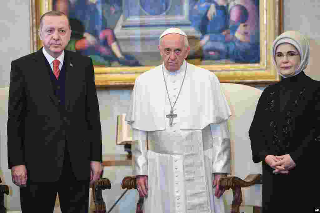 Turkish President Recep Tayyip Erdogan, left, and his wife Emine, right, meet Pope Francis at the Vatican.